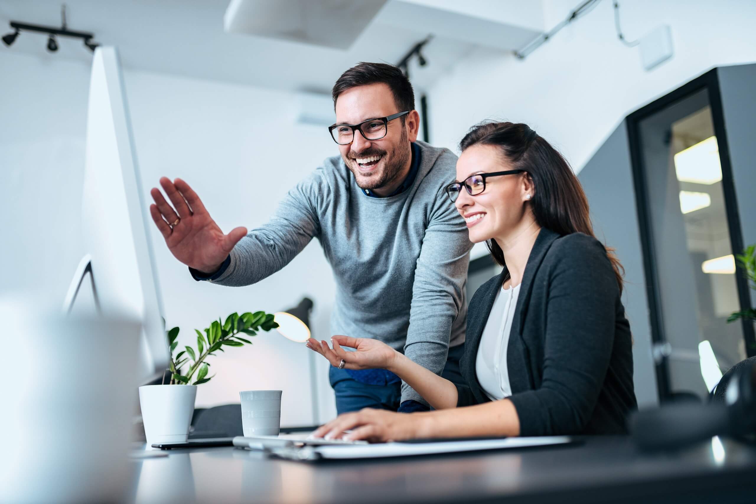 Man and women looking at computer