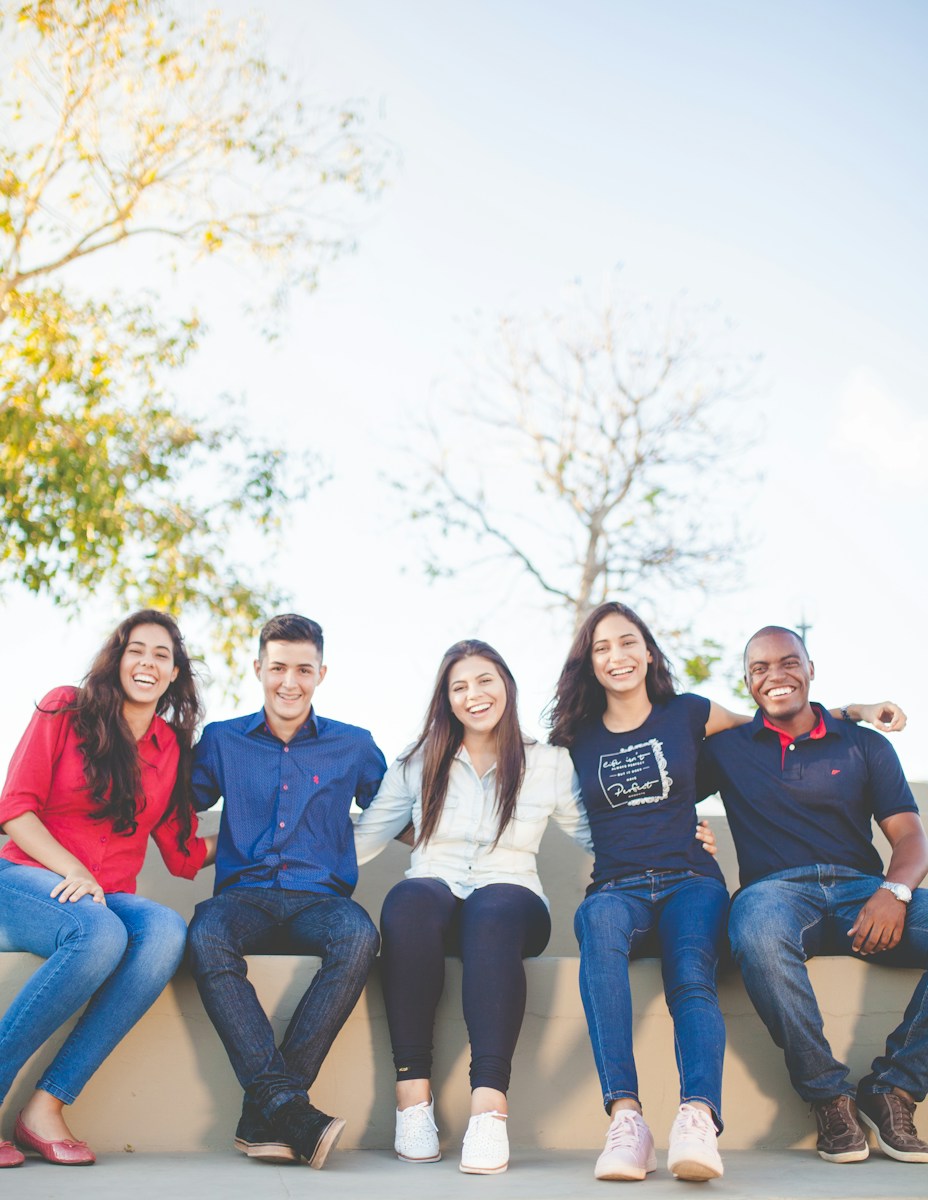 A group of people, mixed age and gender sat together.